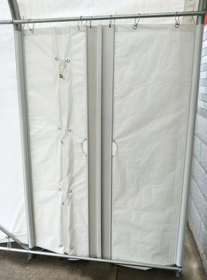 Porte latérale en toile blanche installée sur la structure d’un abri d’auto.